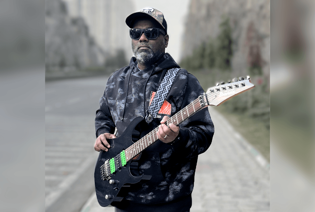 Joel Sastry with electric guitar